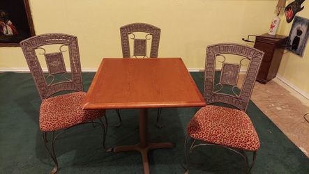 Table and 3 red leopard oak chairs