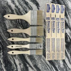 5 paintbrushes and 4 paint mixer sticks 