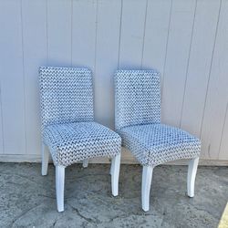 2 white wicker chairs