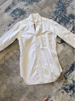 Thom Browne men shirt size 2 like size M Purchased at south coast mall original price was $650 before tax. Let me know if you need details photos