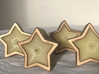 Twelve 7 oz. Holiday Inspirations Star Shape Terra Cotta Pot Candle.