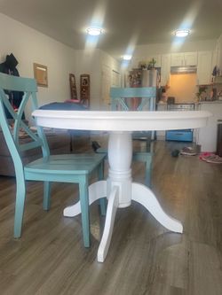 White table with teal chairs