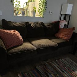 Brown couch with pillows 