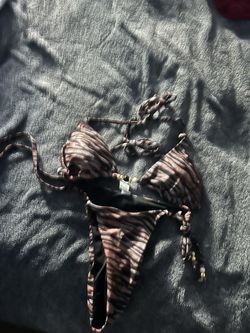 brown and cream animal print triangle bikini set with tie details and gold-toned beads.
