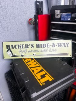 Hacker's Hide-A-Way: Golf stories told here" long metal wall sign.