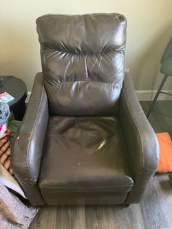 Brown leather chair. Leans back