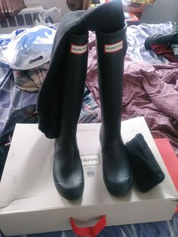 A brand new pair of Hunter rain boots with the socks