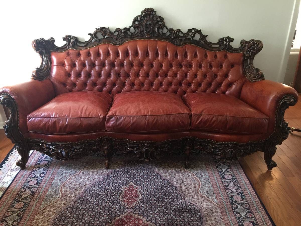 GORGEOUS antique leather couch from Italy. With hand carved wood trim