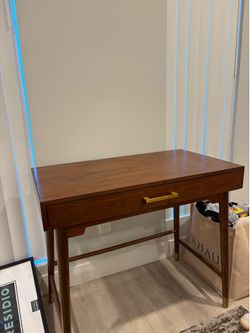 Dark wood desk with gold handle