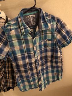 Blue short sleeve plaid shirt size XL for an 8/9 year old boy. Blue shade color.