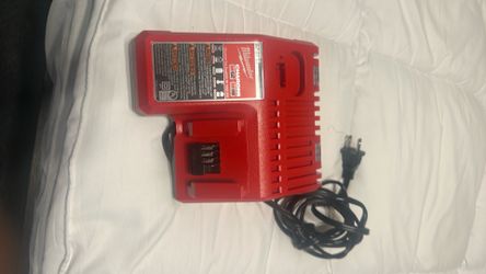 Milwaukee M12 &  battery charger and One M18 XC 5.0 battery  and a M18 XC 3.0 battery