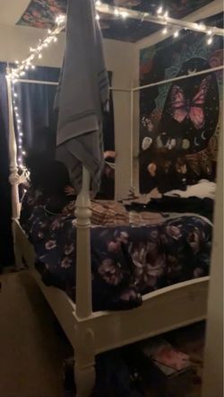 White full sized bed frame and end table
