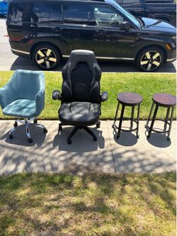 Two office/desk chairs one is gaming and two bar stools