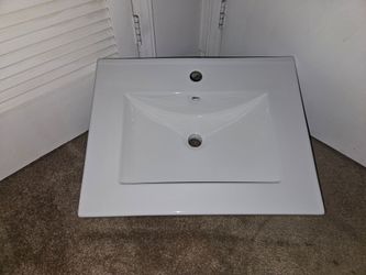 White ceramic bath vanity top with overflow