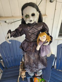 Creepy animatronic girl and doll