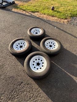 4 old trailer tires with rims