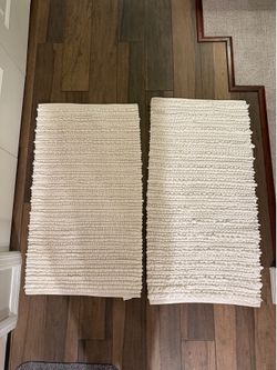 2 white bath rugs