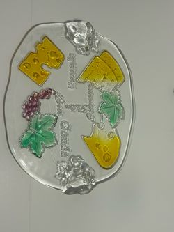 This is a Walther Glass "Siebenstern" cheese platter featuring embossed designs of grapes and various cheeses