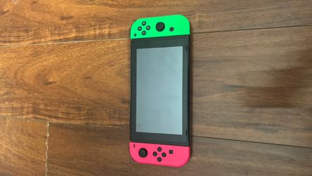 Original Nintendo, red controller + neon pink and green splatoon controllers + animal crossing new horizon game card
