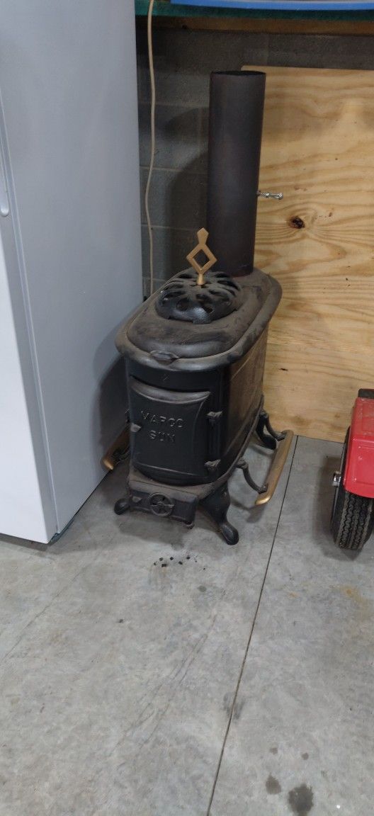 Antique Wood Stove And Four Sections Of Insulated Pipe.