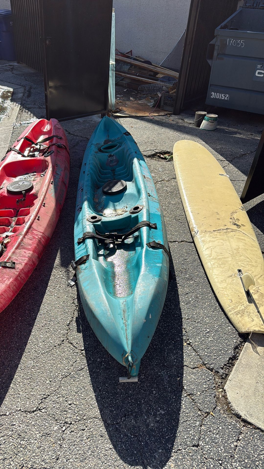 Surfboard And 2 Kayaks