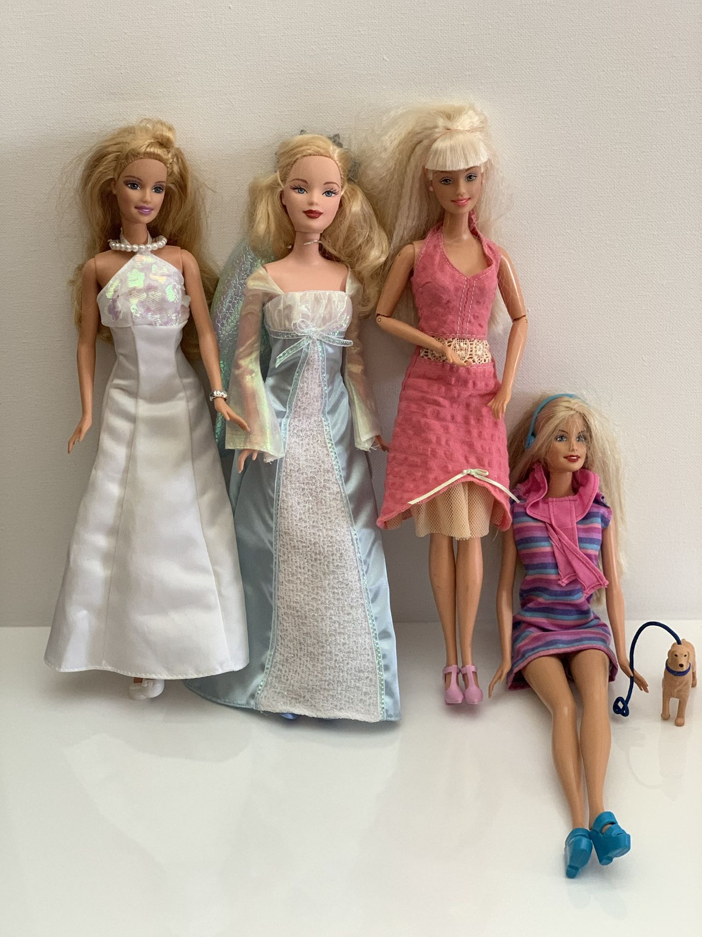 4 Barbie Dolls & small dog accessory