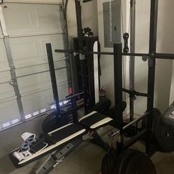Rogue Olympic Barbell W/ Rogue Bumper Plates. Marcy Squat Rack. Marcy Bench 