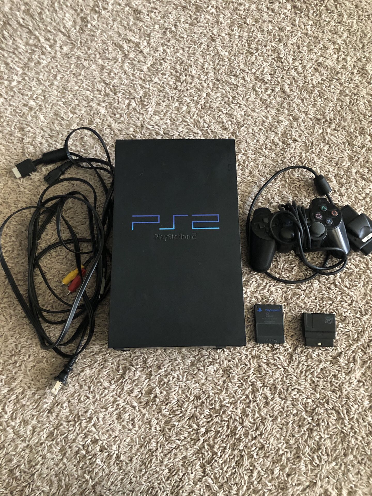 PlayStation 2 with all cables and games pictured