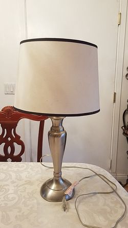 Simple silver color lamp shade with off white shade 2 ft tall. Shade 13" wide 9 " high excellent condition