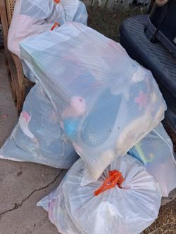 A bunch of toys and some kids clothes