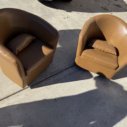 Two Leather Cognac Swivel Chairs