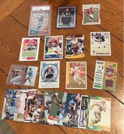 lot of NFL football  cards. Including rookie cards, a Jalen Waddle PSA 10 clear vision rookie card, a rookie jersey card of Bijan Robinson, and so muc