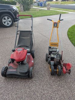 Lawn mower and edger been stored in the garage.