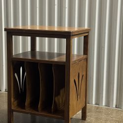 vintage art deco style midcentury modern end table with decorative side cut outs and vertically storage sections for records or magazines 