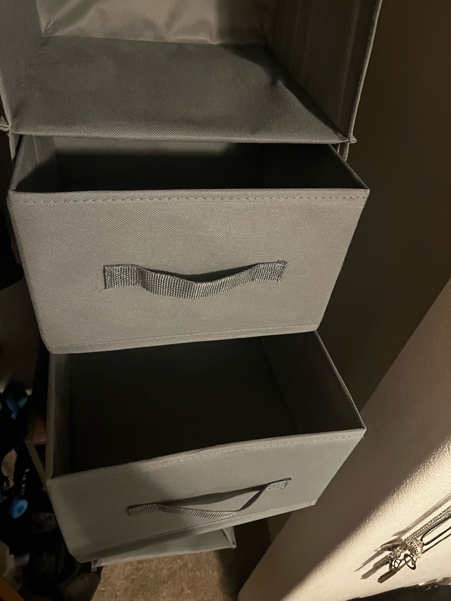 Three grey clothing organizers