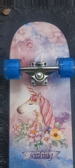 Skateboard with unicorn artwork