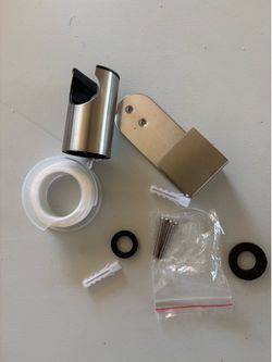 brushed nickel stainless steel holder is designed for wall mounting or hooking onto a toilet tank to hold a hand shower or bidet sprayer