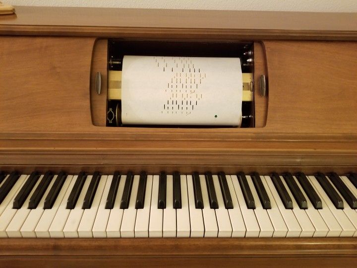 Console Player Piano with Music Rolls