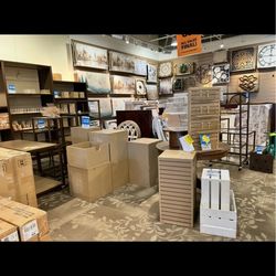 2 & 4 sidedTable top slat”s, glass cube tower displays ,  and wooden white bins.