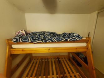 Bunk bed with full bed on the bottom and twin bed on top.