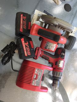 Milwaukee drill and handsaw set.