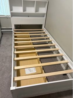 Well-maintained twin-size wooden platform bed in excellent condition