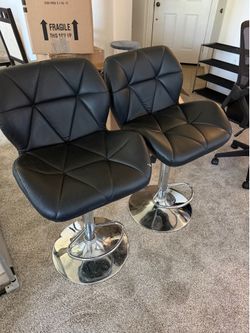 Two faux leather barstools