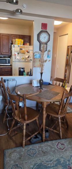 Wooden dining room table with 4 chairs.