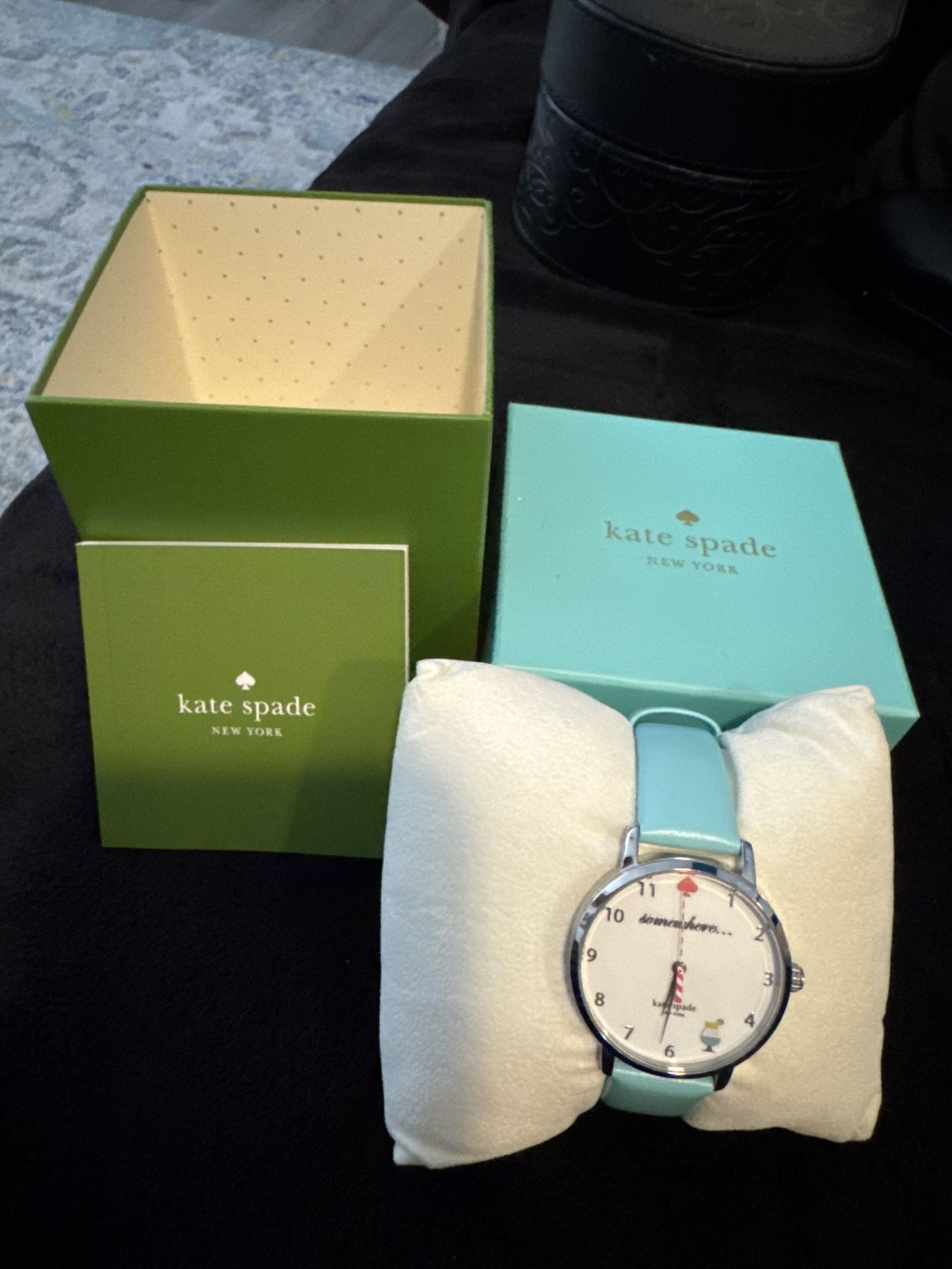 Kate Spade watch, featuring the light blue strap and “somewhere…” cocktail-themed face