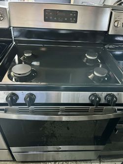 GE gas stove 4 burners and single oven In Black and stainless steel.