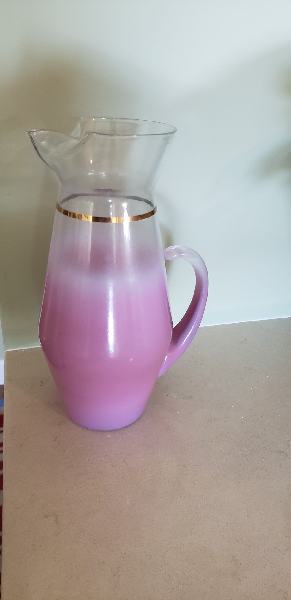 Glass Carafe with 5 matching glasses. Pink with gold trim.