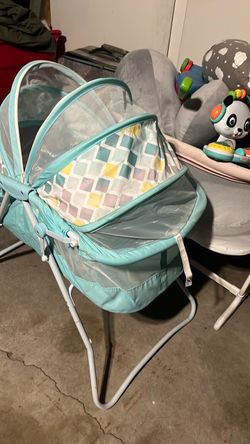 Bassinet with zip up shield/net folds down