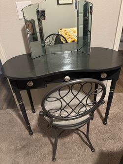 Gray vanity with mirror.