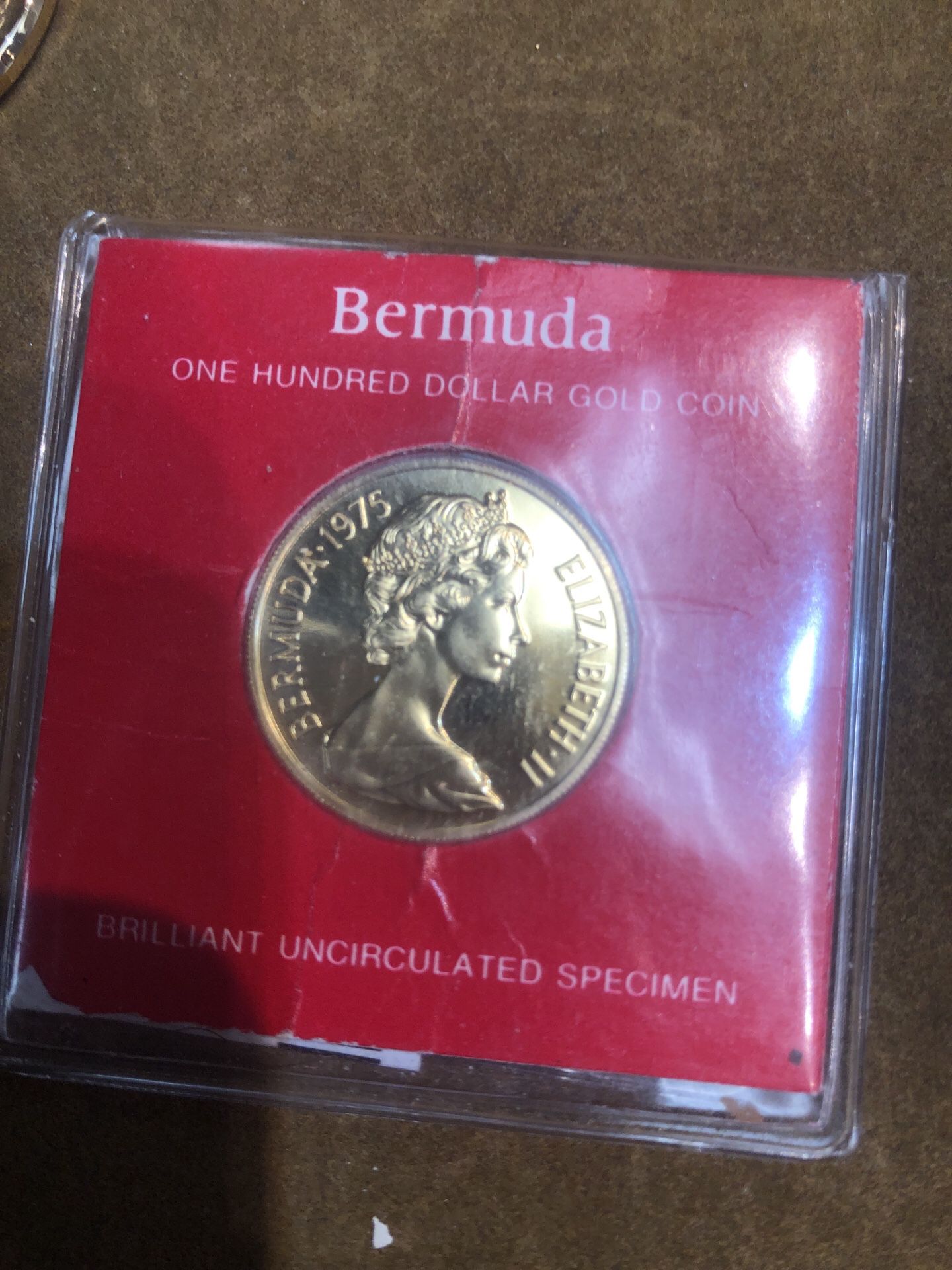 Gold Bermuda one hundred dollar coin. Uncirculated.